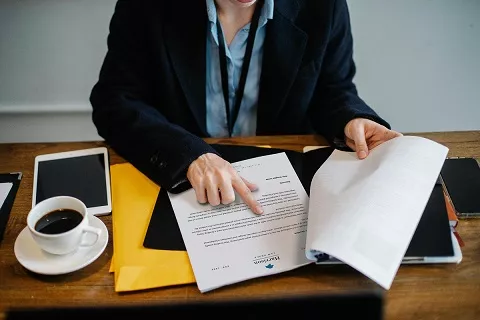 Photo of a person reviewing a contract.