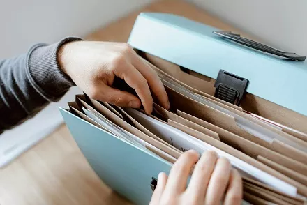 A photo of a person looking through files.