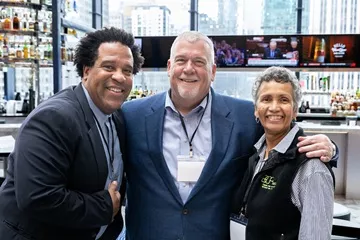 Photo of three people smiling at a CRL event.