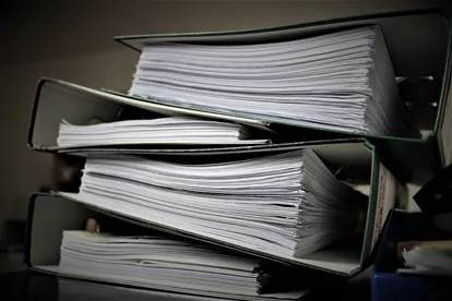 Photo of binders with papers inside of them.
